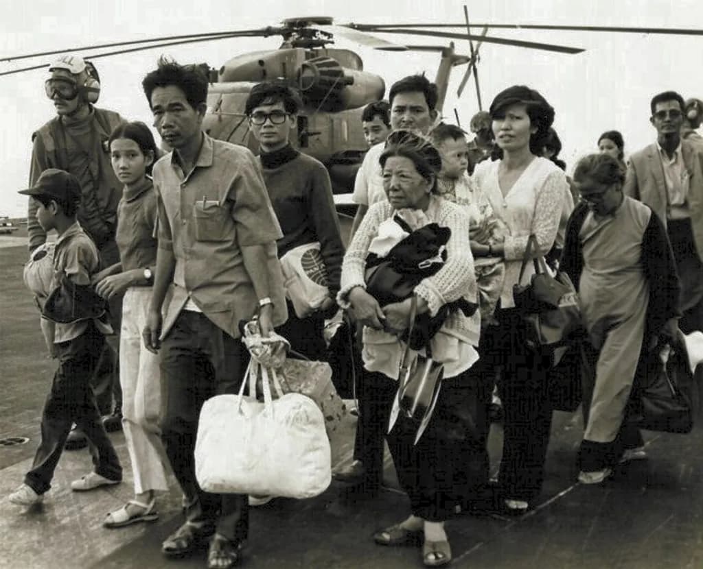 South Vietnamese refugees walk across a U.S. Navy vessel. Operation Frequent Wind, the final operation in Saigon, began April 29, 1975. During a nearly constant barrage of explosions, the Marines loaded American and Vietnamese civilians, who feared for their lives, onto helicopters that brought them to waiting aircraft carriers. The Navy vessels brought them to the Philippines and eventually to Camp Pendleton, Calif.